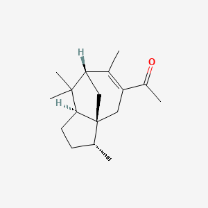 B1664338 1-((3R,3aR,7R,8aS)-3,6,8,8-Tetramethyl-2,3,4,7,8,8a-hexahydro-1H-3a,7-methanoazulen-5-yl)ethanone CAS No. 32388-55-9