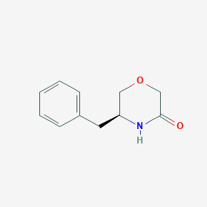 (5S)-5-benzylmorpholin-3-one