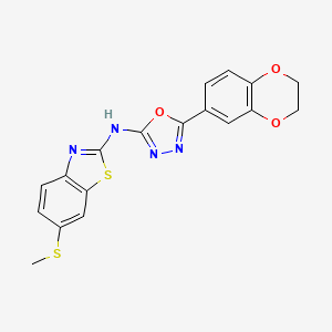 molecular formula C18H14N4O3S2 B2423048 N-[5-(2,3-dihydro-1,4-benzodioxin-6-yl)-1,3,4-oxadiazol-2-yl]-6-(methylsulfanyl)-1,3-benzothiazol-2-amine CAS No. 878061-84-8