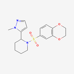 molecular formula C17H21N3O4S B2440719 1-(2,3-dihydro-1,4-benzodioxine-6-sulfonyl)-2-(1-methyl-1H-pyrazol-5-yl)piperidine CAS No. 2310097-68-6