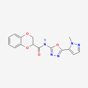 molecular formula C15H13N5O4 B2448563 N-(5-(1-methyl-1H-pyrazol-5-yl)-1,3,4-oxadiazol-2-yl)-2,3-dihydrobenzo[b][1,4]dioxine-2-carboxamide CAS No. 1172867-55-8