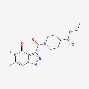 molecular formula C15H19N5O4 B2483841 Ethyl 1-[(6-methyl-4-oxo-4,5-dihydro[1,2,3]triazolo[1,5-a]pyrazin-3-yl)carbonyl]piperidine-4-carboxylate CAS No. 1993167-10-4