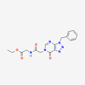 molecular formula C17H18N6O4 B2533852 ethyl 2-(2-{3-benzyl-7-oxo-3H,6H,7H-[1,2,3]triazolo[4,5-d]pyrimidin-6-yl}acetamido)acetate CAS No. 892469-33-9