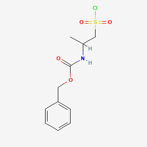 molecular formula C11H14ClNO4S B2567454 benzyl N-[1-(chlorosulfonyl)propan-2-yl]carbamate CAS No. 1784671-22-2