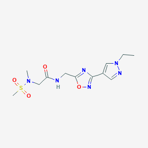 molecular formula C12H18N6O4S B2577015 N-{[3-(1-ethyl-1H-pyrazol-4-yl)-1,2,4-oxadiazol-5-yl]methyl}-2-(N-methylmethanesulfonamido)acetamide CAS No. 2180010-54-0