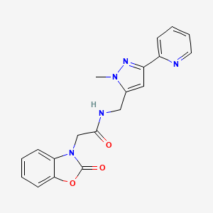 molecular formula C19H17N5O3 B2590228 N-{[1-methyl-3-(pyridin-2-yl)-1H-pyrazol-5-yl]methyl}-2-(2-oxo-2,3-dihydro-1,3-benzoxazol-3-yl)acetamide CAS No. 2319723-20-9