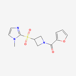 molecular formula C12H13N3O4S B2602357 2-{[1-(furan-2-carbonyl)azetidin-3-yl]sulfonyl}-1-methyl-1H-imidazole CAS No. 2309571-45-5