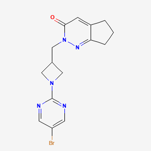 B2701805 2-{[1-(5-bromopyrimidin-2-yl)azetidin-3-yl]methyl}-2H,3H,5H,6H,7H-cyclopenta[c]pyridazin-3-one CAS No. 2175979-30-1