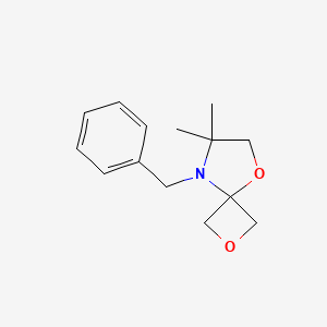 B2702537 8-Benzyl-7,7-dimethyl-2,5-dioxa-8-azaspiro[3.4]octane CAS No. 1556097-39-2
