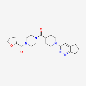 1-(1-{5H,6H,7H-cyclopenta[c]pyridazin-3-yl}piperidine-4-carbonyl)-4-(oxolane-2-carbonyl)piperazine