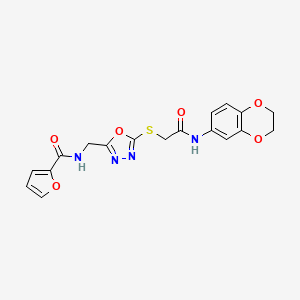 molecular formula C18H16N4O6S B2741840 N-{[5-({[(2,3-DIHYDRO-1,4-BENZODIOXIN-6-YL)CARBAMOYL]METHYL}SULFANYL)-1,3,4-OXADIAZOL-2-YL]METHYL}FURAN-2-CARBOXAMIDE CAS No. 851862-27-6
