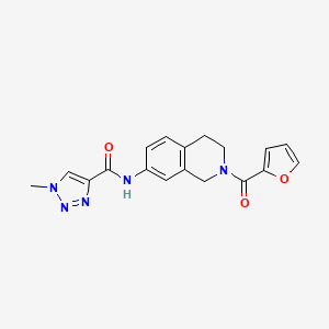 molecular formula C18H17N5O3 B2767864 N-(2-(furan-2-carbonyl)-1,2,3,4-tetrahydroisoquinolin-7-yl)-1-methyl-1H-1,2,3-triazole-4-carboxamide CAS No. 1448132-09-9