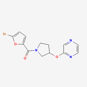 molecular formula C13H12BrN3O3 B2770528 (5-Bromofuran-2-yl)(3-(pyrazin-2-yloxy)pyrrolidin-1-yl)methanone CAS No. 2034582-75-5