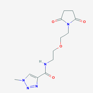 molecular formula C12H17N5O4 B2770972 N-(2-(2-(2,5-dioxopyrrolidin-1-yl)ethoxy)ethyl)-1-methyl-1H-1,2,3-triazole-4-carboxamide CAS No. 2320572-26-5