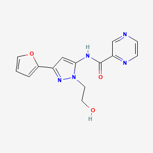 molecular formula C14H13N5O3 B2772444 N-(3-(furan-2-yl)-1-(2-hydroxyethyl)-1H-pyrazol-5-yl)pyrazine-2-carboxamide CAS No. 1219906-21-4