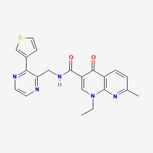 1-ethyl-7-methyl-4-oxo-N-((3-(thiophen-3-yl)pyrazin-2-yl)methyl)-1,4-dihydro-1,8-naphthyridine-3-carboxamide