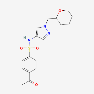molecular formula C17H21N3O4S B2869313 4-acetyl-N-{1-[(oxan-2-yl)methyl]-1H-pyrazol-4-yl}benzene-1-sulfonamide CAS No. 2034529-76-3