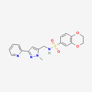 molecular formula C18H18N4O4S B2924118 N-{[1-methyl-3-(pyridin-2-yl)-1H-pyrazol-5-yl]methyl}-2,3-dihydro-1,4-benzodioxine-6-sulfonamide CAS No. 2319639-89-7