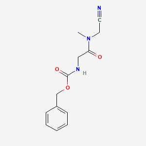 molecular formula C13H15N3O3 B2946539 benzyl N-{[(cyanomethyl)(methyl)carbamoyl]methyl}carbamate CAS No. 1311683-20-1