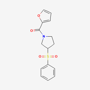 molecular formula C15H15NO4S B2980837 Furan-2-yl(3-(phenylsulfonyl)pyrrolidin-1-yl)methanone CAS No. 1448073-67-3