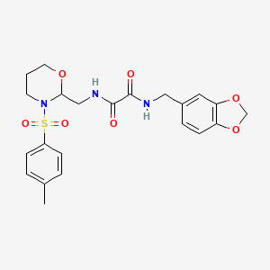 B3009702 N1-(benzo[d][1,3]dioxol-5-ylmethyl)-N2-((3-tosyl-1,3-oxazinan-2-yl)methyl)oxalamide CAS No. 869071-36-3
