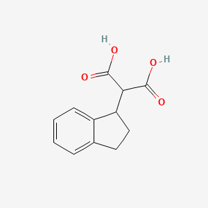 molecular formula C12H12O4 B3025495 2-(2,3-dihydro-1H-inden-1-yl)propanedioic acid CAS No. 195071-06-8