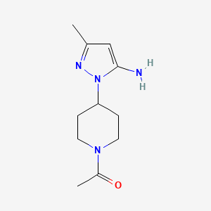 B3027727 1-[4-(5-Amino-3-methyl-1H-pyrazol-1-yl)piperidin-1-yl]ethan-1-one CAS No. 1365988-13-1