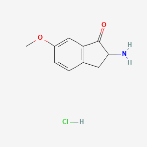 B3053567 2-Amino-6-methoxy-1-indanone hydrochloride CAS No. 5450-76-0