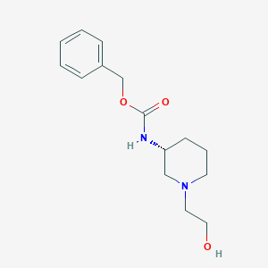 B3235554 [(R)-1-(2-Hydroxy-ethyl)-piperidin-3-yl]-carbamic acid benzyl ester CAS No. 1354019-52-5