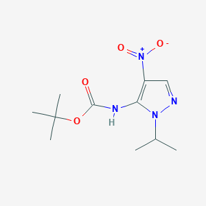 molecular formula C11H18N4O4 B3252468 t-Butyl (1-isopropyl-4-nitro-1H-pyrazol-5-yl)carbamate CAS No. 2171314-47-7