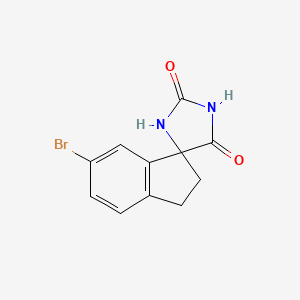 molecular formula C11H9BrN2O2 B3324508 6'-Bromo-2',3'-dihydrospiro[imidazolidine-4,1'-indene]-2,5-dione CAS No. 1880205-67-3