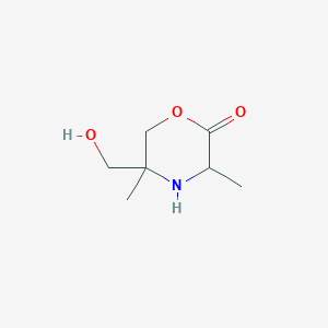 molecular formula C7H13NO3 B049712 5-(Hydroxymethyl)-3,5-dimethylmorpholin-2-one CAS No. 113464-60-1