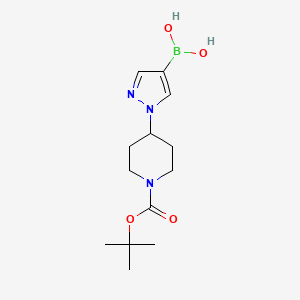 B566044 (1-(1-(tert-Butoxycarbonyl)piperidin-4-yl)-1H-pyrazol-4-yl)boronic acid CAS No. 1190875-39-8