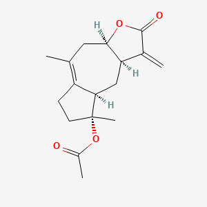 molecular formula C17H22O4 B576458 [(3aR,8R,8aR,9aR)-5,8-dimethyl-1-methylidene-2-oxo-4,6,7,8a,9,9a-hexahydro-3aH-azuleno[6,7-b]furan-8-yl] acetate CAS No. 1461-36-5