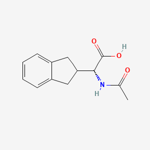 molecular formula C13H15NO3 B581867 (R)-2-Acetamido-2-(2,3-dihydro-1H-inden-2-yl)acetic acid CAS No. 179185-77-4