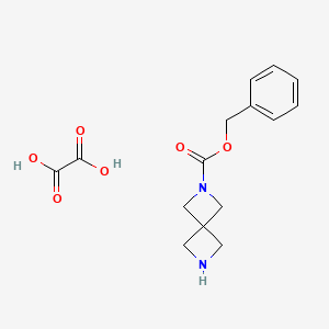 molecular formula C15H18N2O6 B597817 Benzyl 2,6-diazaspiro[3.3]heptane-2-carboxylate oxalate CAS No. 1211517-23-5
