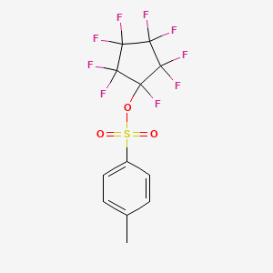 B6311877 1,2,2,3,3,4,4,5,5-Nonafluorocyclopentyl tosylate CAS No. 1357623-72-3