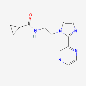molecular formula C13H15N5O B6428264 N-{2-[2-(pyrazin-2-yl)-1H-imidazol-1-yl]ethyl}cyclopropanecarboxamide CAS No. 2034507-99-6
