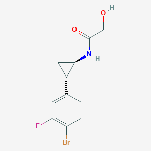 molecular formula C11H11BrFNO2 B6716782 N-[(1R,2S)-2-(4-bromo-3-fluorophenyl)cyclopropyl]-2-hydroxyacetamide 