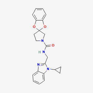 molecular formula C22H22N4O3 B6789790 N-[(1-cyclopropylbenzimidazol-2-yl)methyl]spiro[1,3-benzodioxole-2,3'-pyrrolidine]-1'-carboxamide 