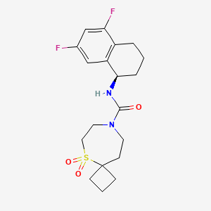molecular formula C19H24F2N2O3S B6802995 N-[(1R)-5,7-difluoro-1,2,3,4-tetrahydronaphthalen-1-yl]-5,5-dioxo-5lambda6-thia-8-azaspiro[3.6]decane-8-carboxamide 