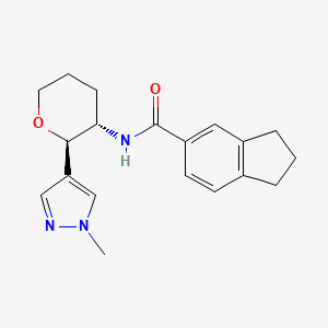 molecular formula C19H23N3O2 B6865567 N-[(2R,3S)-2-(1-methylpyrazol-4-yl)oxan-3-yl]-2,3-dihydro-1H-indene-5-carboxamide 