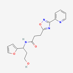 molecular formula C17H18N4O4 B6936830 N-[1-(furan-2-yl)-3-hydroxypropyl]-3-(3-pyridin-2-yl-1,2,4-oxadiazol-5-yl)propanamide 