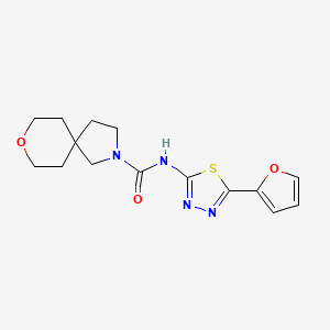 molecular formula C15H18N4O3S B7187939 N-[5-(furan-2-yl)-1,3,4-thiadiazol-2-yl]-8-oxa-2-azaspiro[4.5]decane-2-carboxamide 