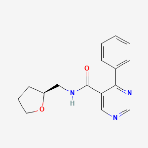 molecular formula C16H17N3O2 B7341489 N-[[(2S)-oxolan-2-yl]methyl]-4-phenylpyrimidine-5-carboxamide 