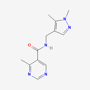 molecular formula C12H15N5O B7411694 N-[(1,5-dimethylpyrazol-4-yl)methyl]-4-methylpyrimidine-5-carboxamide 