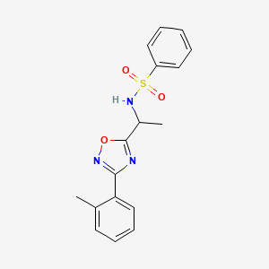 molecular formula C17H17N3O3S B7715774 N-[1-[3-(2-methylphenyl)-1,2,4-oxadiazol-5-yl]ethyl]benzenesulfonamide 
