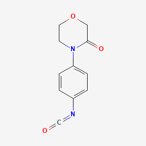 molecular formula C11H10N2O3 B8027378 4-(4-Isocyanatophenyl)morpholin-3-one 