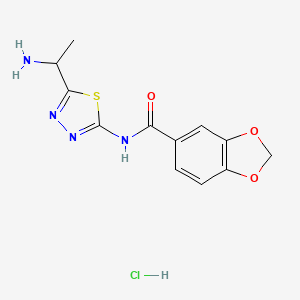 molecular formula C12H13ClN4O3S B8035015 N-[5-(1-aminoethyl)-1,3,4-thiadiazol-2-yl]-1,3-benzodioxole-5-carboxamide;hydrochloride 