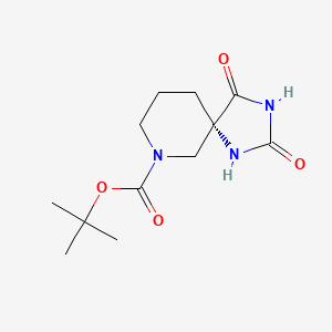 molecular formula C12H19N3O4 B8064146 tert-butyl (5S)-2,4-dioxo-1,3,9-triazaspiro[4.5]decane-9-carboxylate 